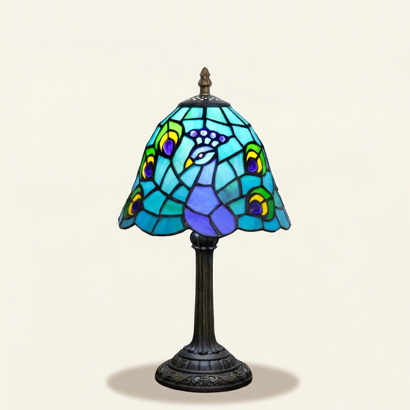 Pavonne 8 Inch Tiffany-style stained glass table lamp, lit, on a plain ivory studio background