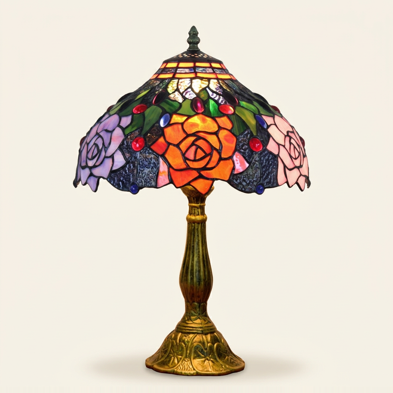 Corvina 12 Inch Tiffany-style stained glass table lamp, Curved Pole base, lit, on a plain ivory studio background