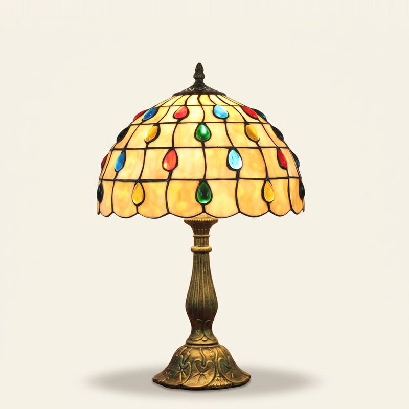 Perlina 12 Inch Tiffany-style stained glass table lamp, Curved Pole base, lit, on a plain ivory studio background
