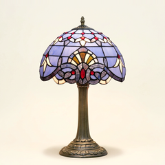 Bellamont 12 Inch Tiffany-style stained glass table lamp, Straight Pole base, lit, on a plain ivory studio background
