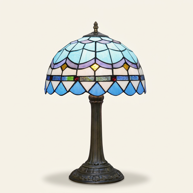 Marbella 12 Inch Tiffany-style stained glass table lamp, lit, on a plain ivory studio background