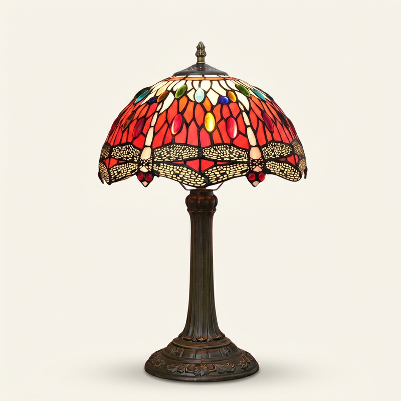 Rubellis 12 Inch Tiffany-style stained glass table lamp, lit, on a plain ivory studio background