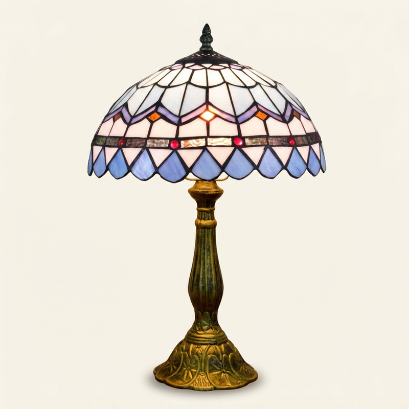 Bellamar 12 Inch Tiffany-style stained glass table lamp, lit, on a plain ivory studio background