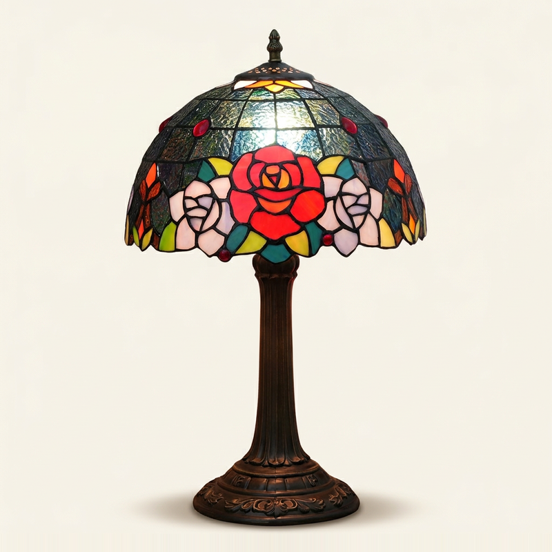 Dorabella 12 Inch Tiffany-style stained glass table lamp, Straight Pole base, lit, on a plain ivory studio background