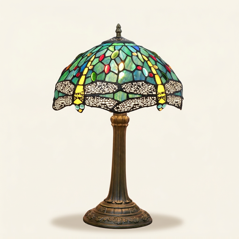 Caelith 12 Inch Tiffany-style stained glass table lamp, lit, on a plain ivory studio background