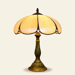 Sienne 12 Inch Tiffany-style stained glass table lamp, Curved Pole base, lit, on a plain ivory studio background