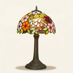 Muscadelle 12 Inch Tiffany-style stained glass table lamp, Straight Pole base, lit, on a plain ivory studio background