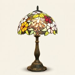 Muscadelle 12 Inch Tiffany-style stained glass table lamp, Curved Pole base, lit, on a plain ivory studio background
