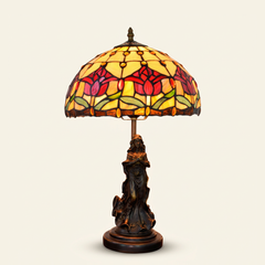 Tulira 12 Inch Tiffany-style stained glass table lamp, Angelic Pole base, lit, on a plain ivory studio background