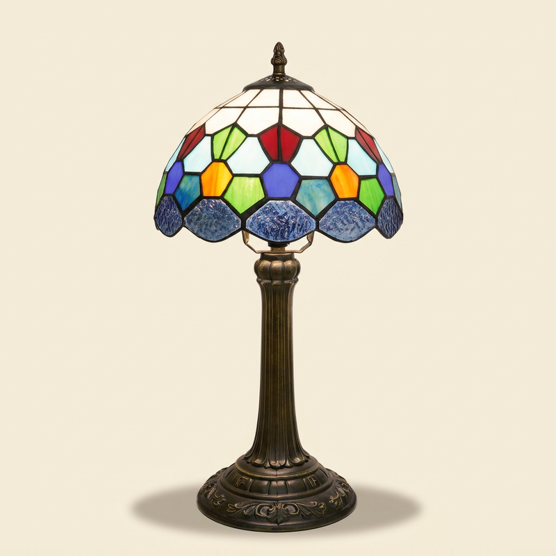 Marquise 10 Inch Tiffany-style stained glass table lamp, lit, on a plain ivory studio background