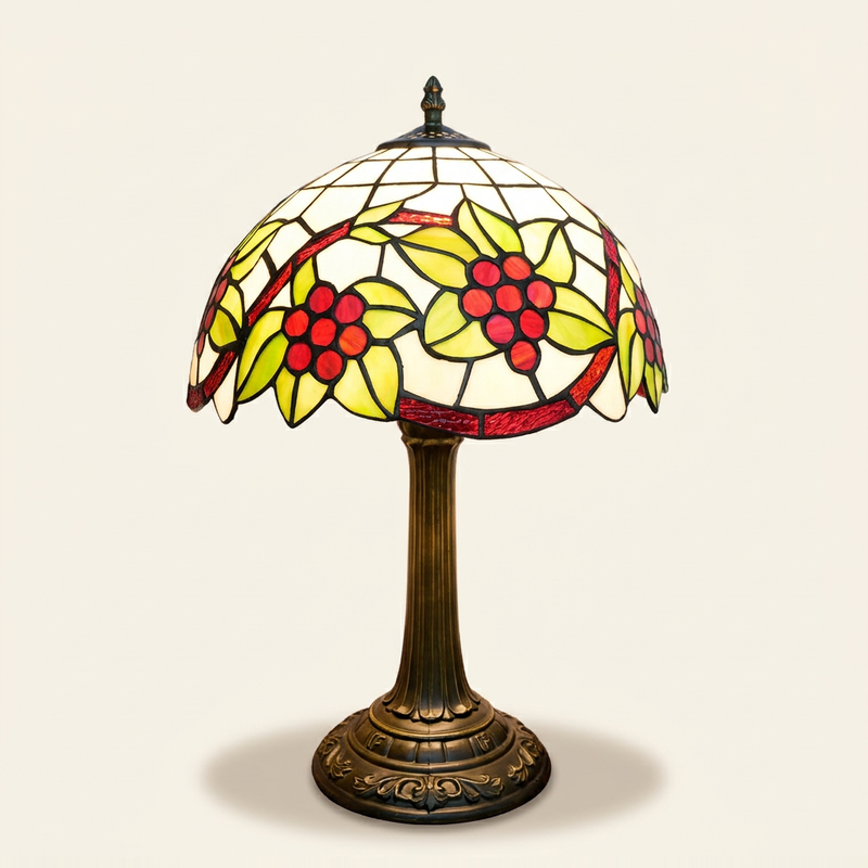 Vignola 12 Inch Tiffany-style stained glass table lamp, lit, on a plain ivory studio background
