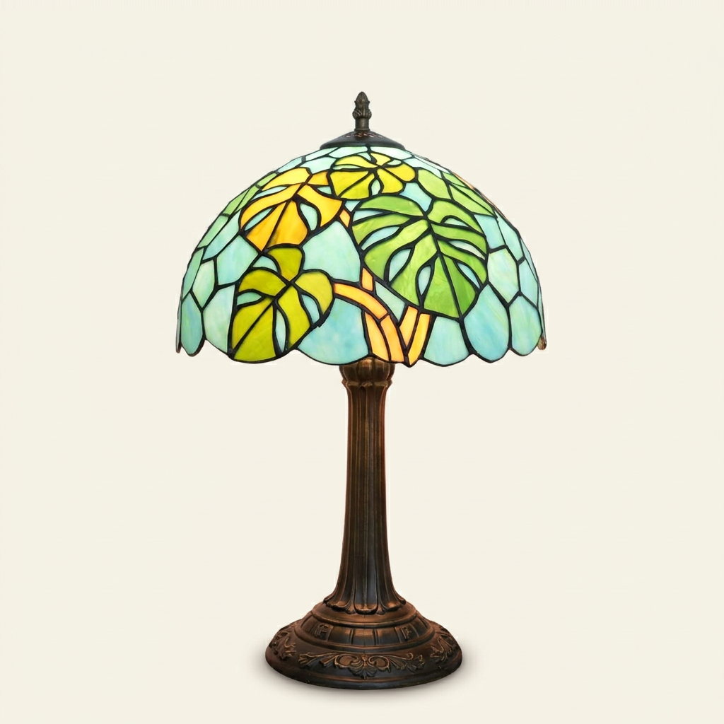 Takami 12 Inch Tiffany-style stained glass table lamp, lit, on a plain ivory studio background