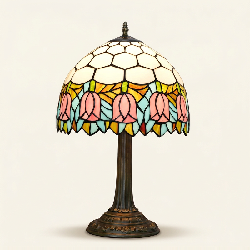 Tulippa 12 Inch Tiffany-style stained glass table lamp, Straight Pole base, lit, on a plain ivory studio background