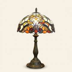Valmont 12 Inch Tiffany-style stained glass table lamp, Curved Pole base, lit, on a plain ivory studio background