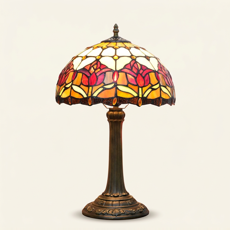 Tulira 12 Inch Tiffany-style stained glass table lamp, Straight Pole base, lit, on a plain ivory studio background