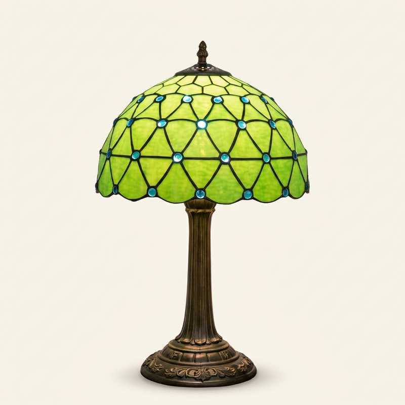 Miravel 12 Inch Tiffany-style stained glass table lamp, lit, on a plain ivory studio background