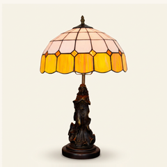 Wexford 12 Inch Tiffany-style stained glass table lamp, Angelic Pole base, lit, on a plain ivory studio background
