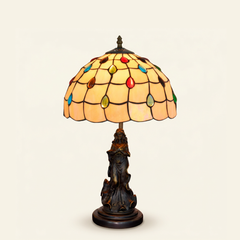 Perlina 12 Inch Tiffany-style stained glass table lamp, Angelic Pole base, lit, on a plain ivory studio background