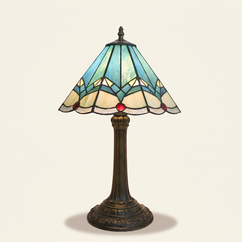 Cyanelle 12 Inch Tiffany-style stained glass table lamp, lit, on a plain ivory studio background