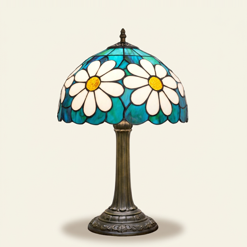 Daisette 12 Inch Tiffany-style stained glass table lamp, lit, on a plain ivory studio background