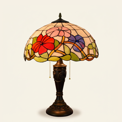 Trillora 16 Inch Tiffany-style stained glass table lamp, Rose Pole base, lit, on a plain ivory studio background