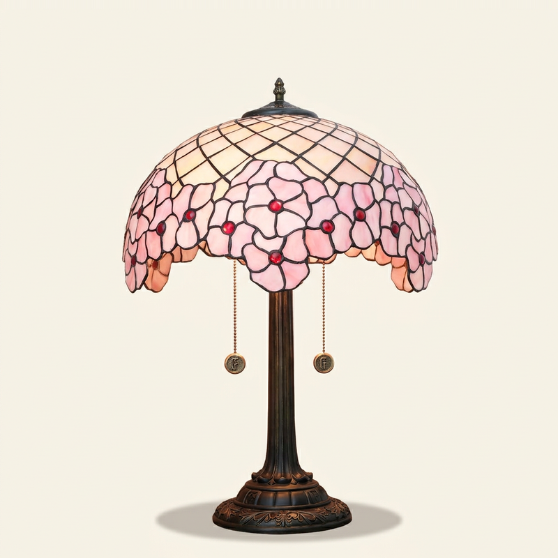 Sakurine 16 Inch Tiffany-style stained glass table lamp, lit, on a plain ivory studio background